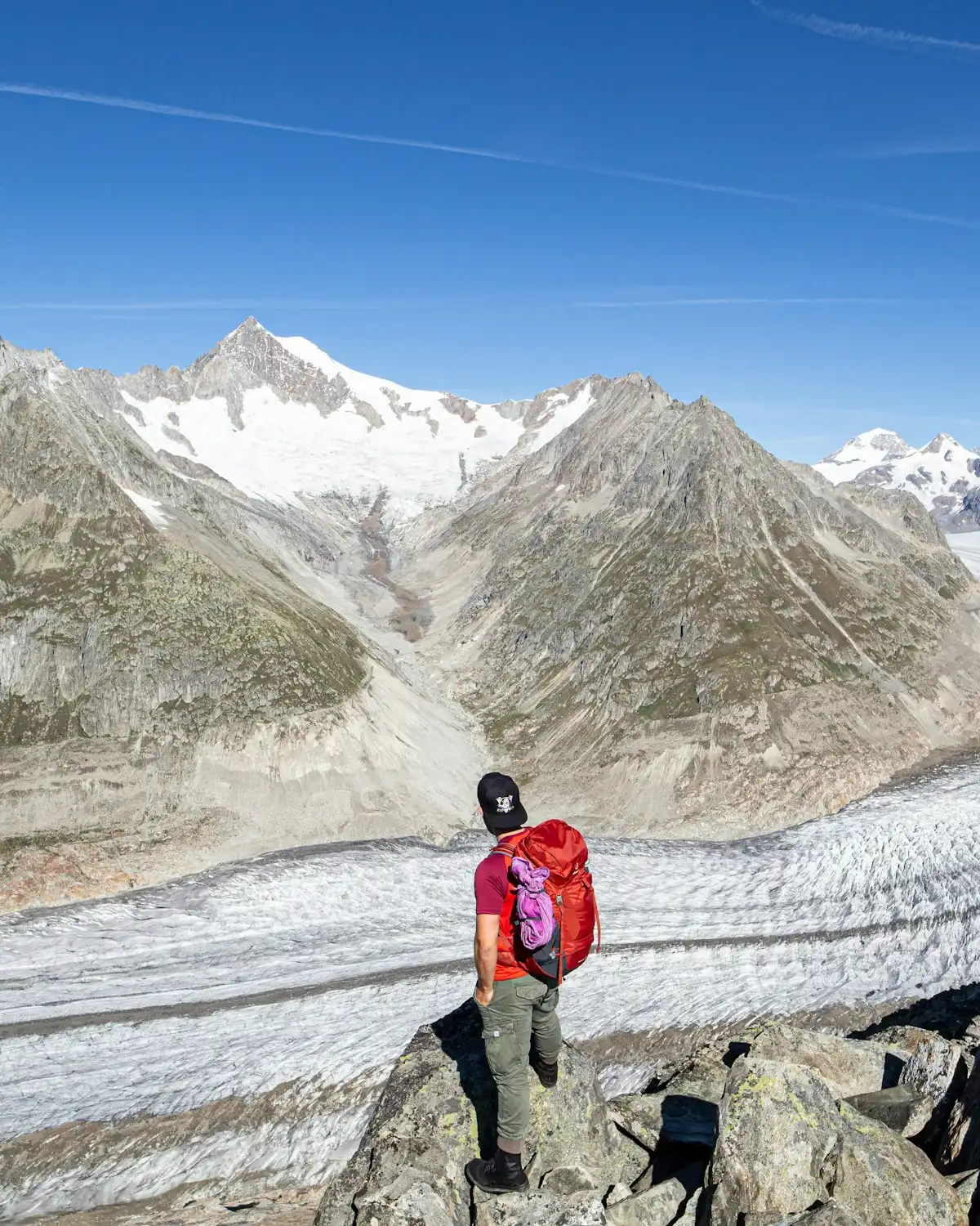 2 person walking on snow covered field near snow covered mountain during daytime — Aletsch Glacier, Switzerland
