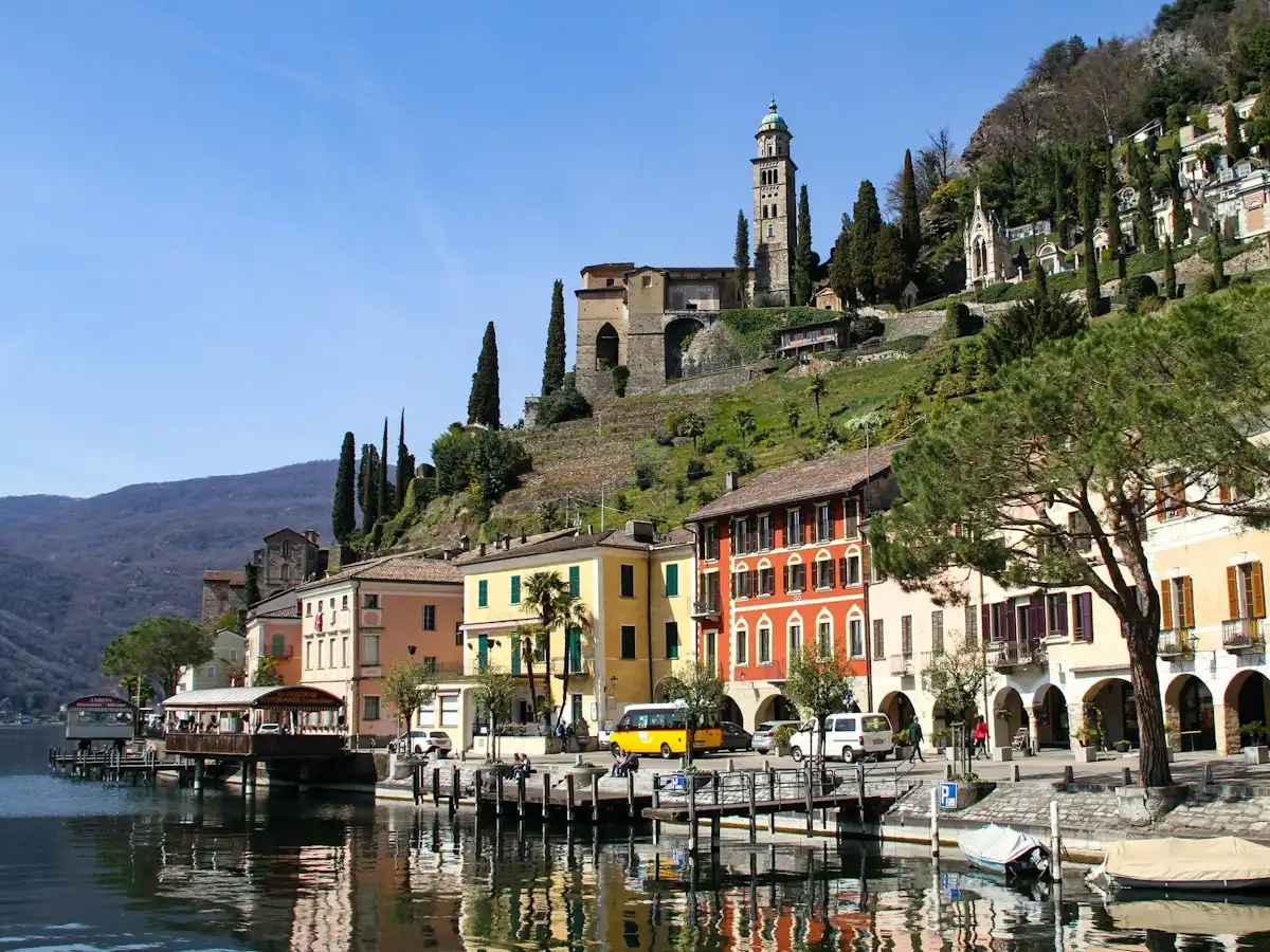 Body of water near buildings during daytime — Morcote, Ticino, Switzerland