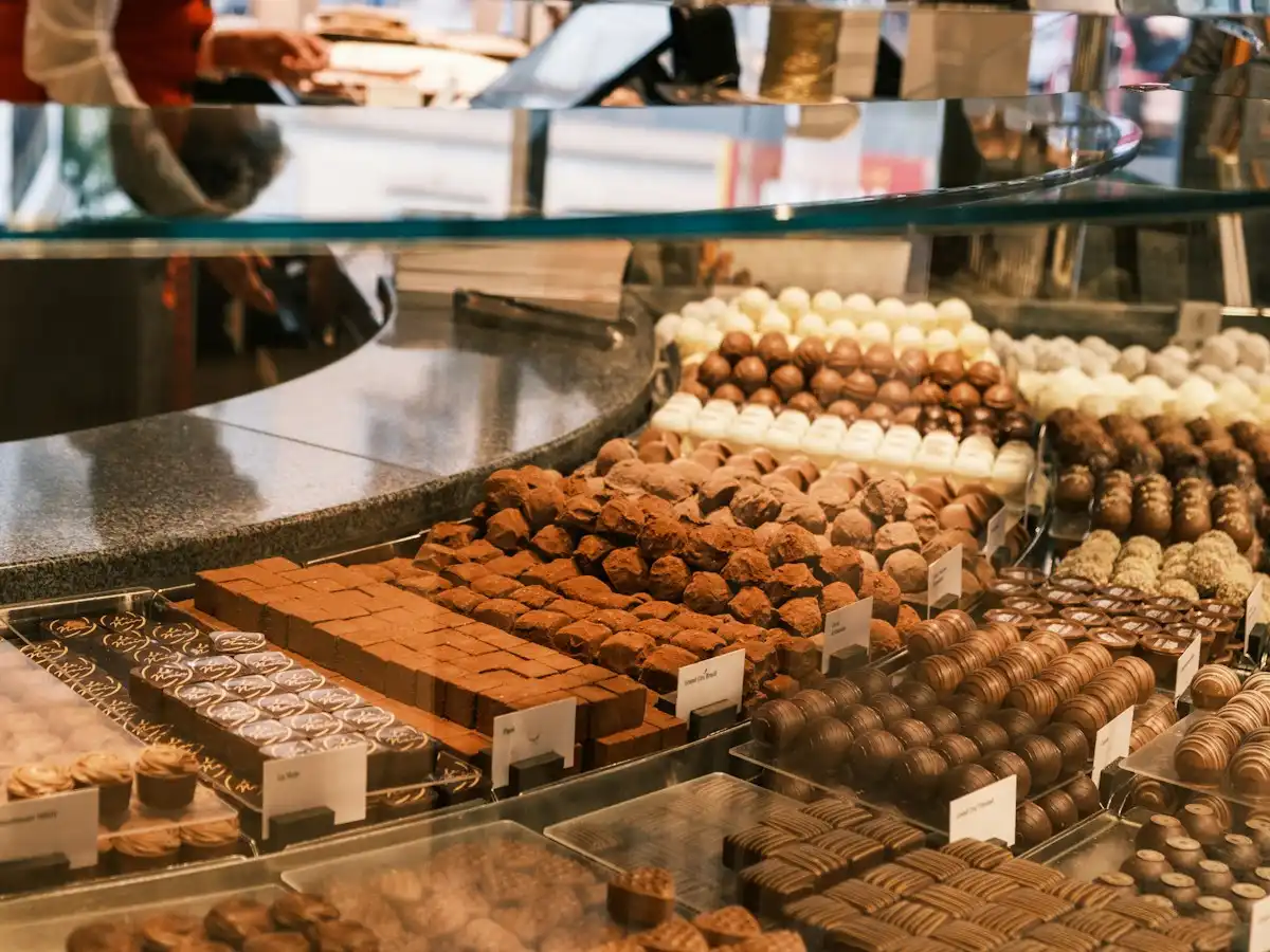 A display case filled with lots of different types of chocolates — Swiss chocolate, Switzerland