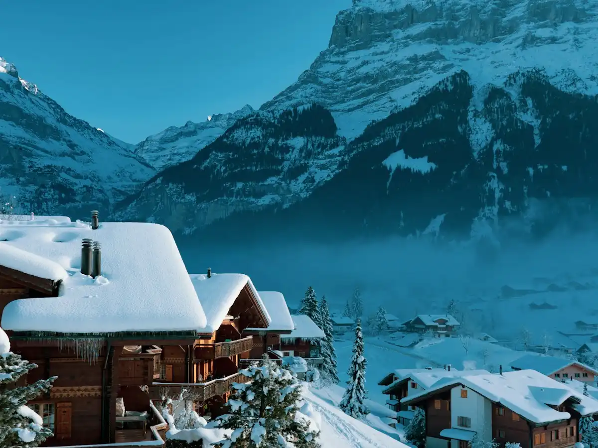 A snow covered mountain with a house in the foreground — Grindelwald, Switzerland