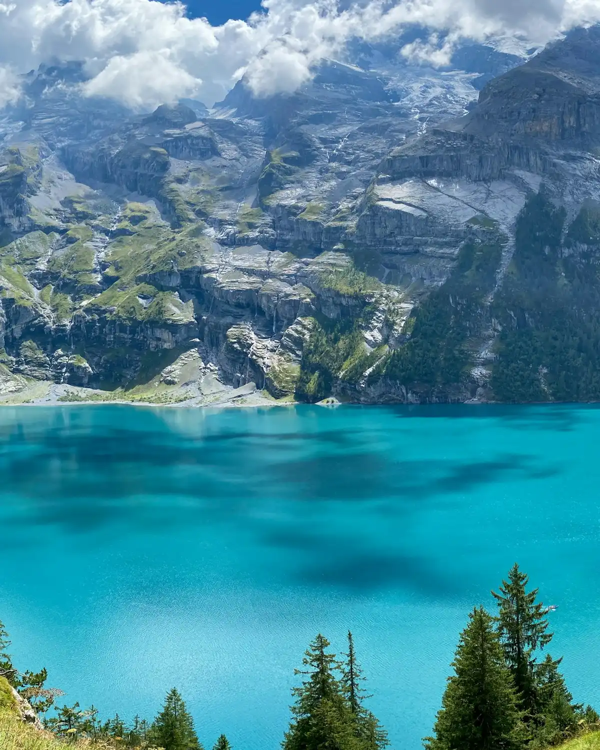 A lake surrounded by mountains — Oeschinensee, Switzerland